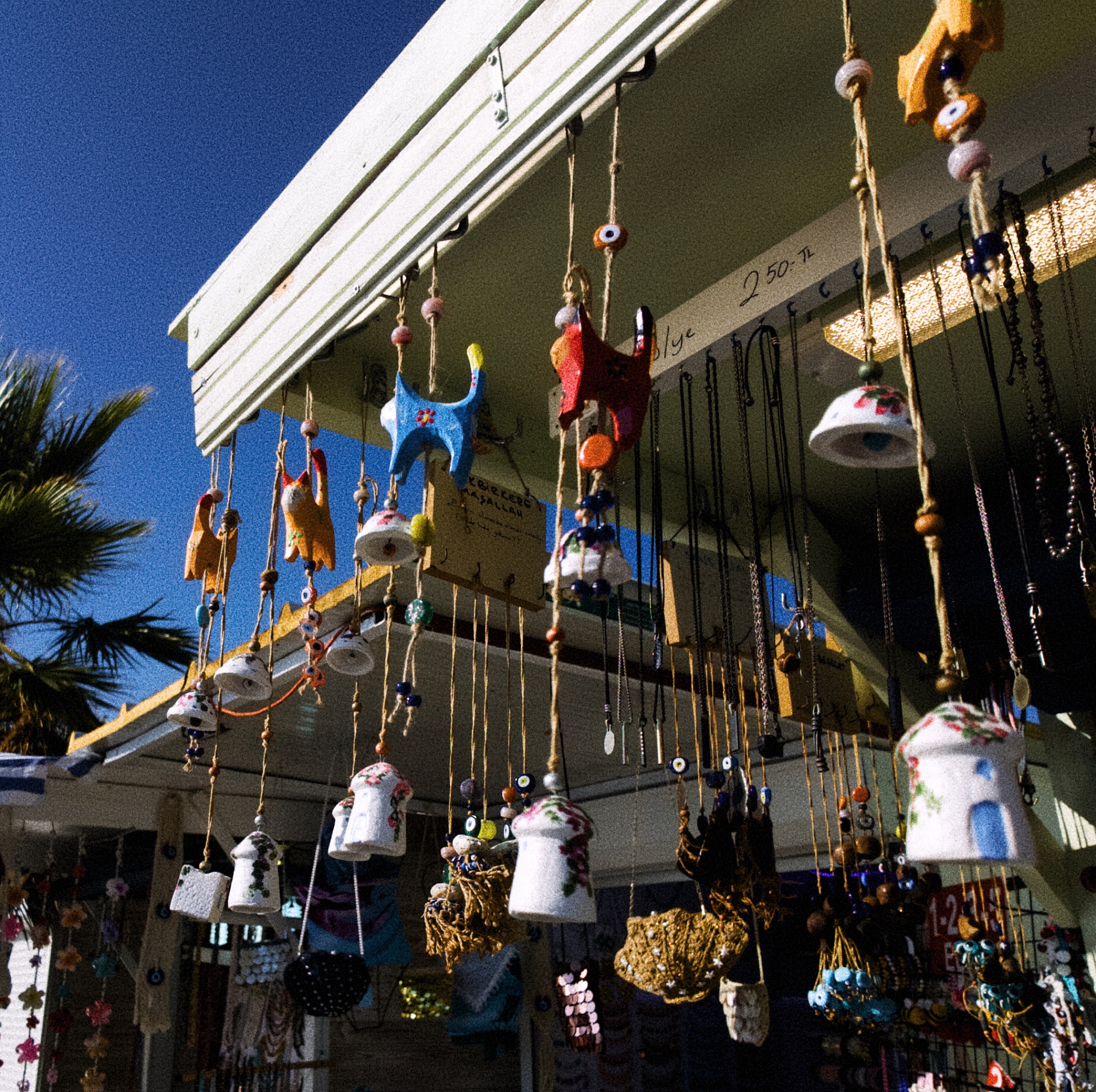Colourful ceramic charms and bells hanging outside a Bodrum shop