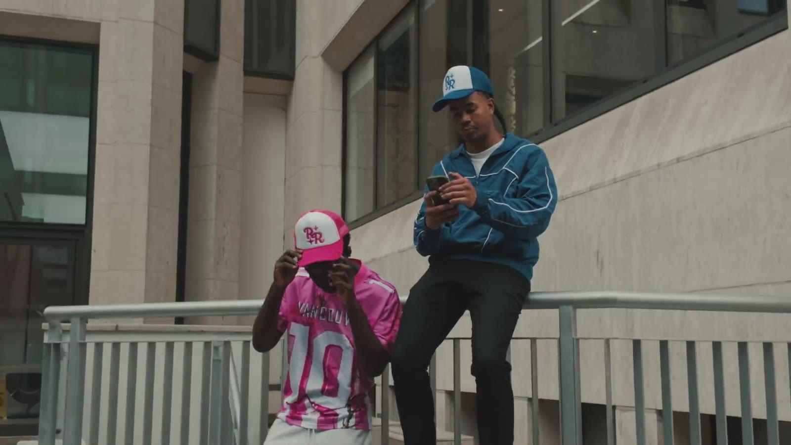 Models wearing Reflect and Renew streetwear in an urban setting