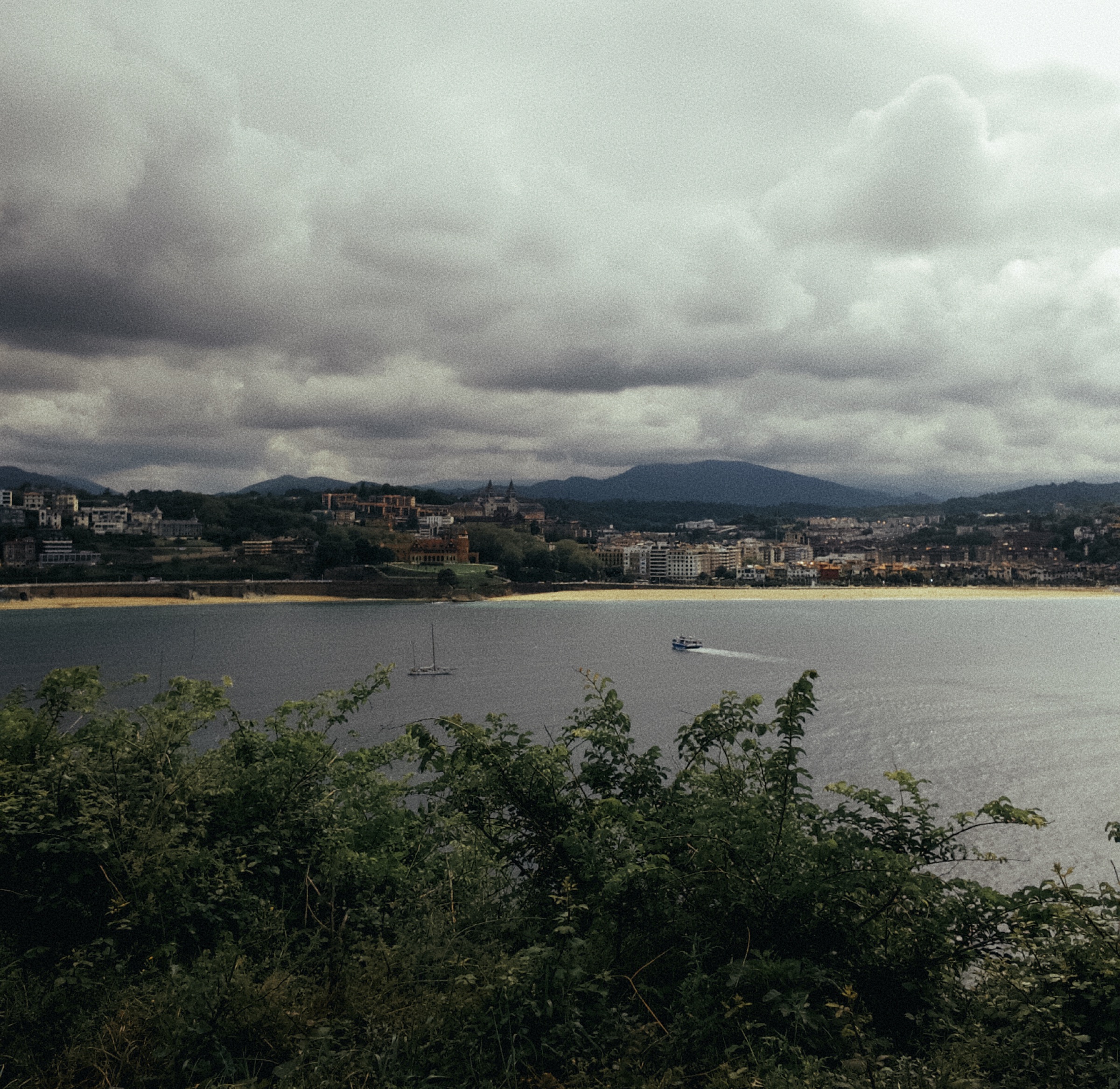 La Concha bay and San Sebastián beneath a dramatic cloudy sky